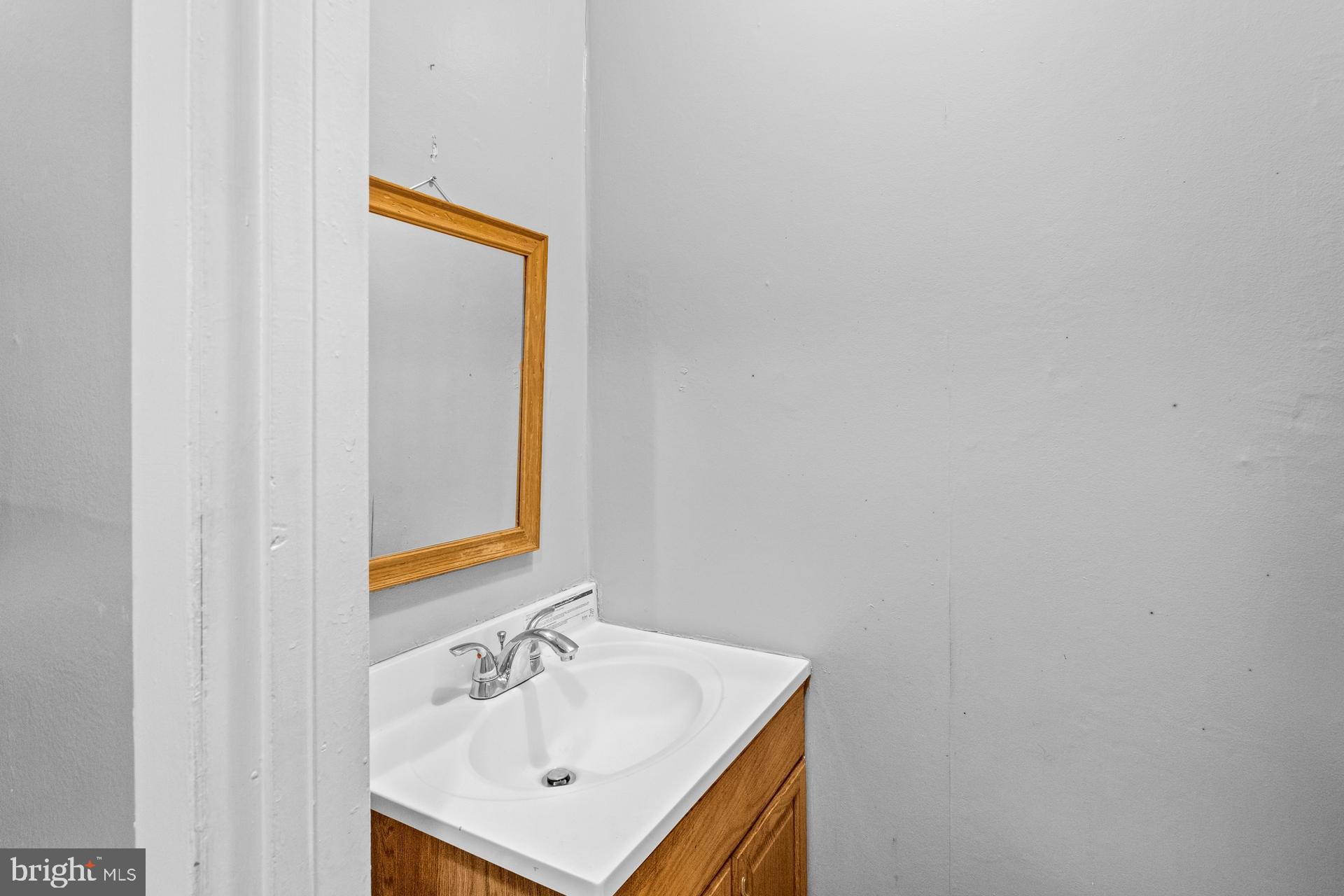 1043 Foster Street Philadelphia, PA 19116 - Photo 8 of 22 a bathroom with a sink and a mirror