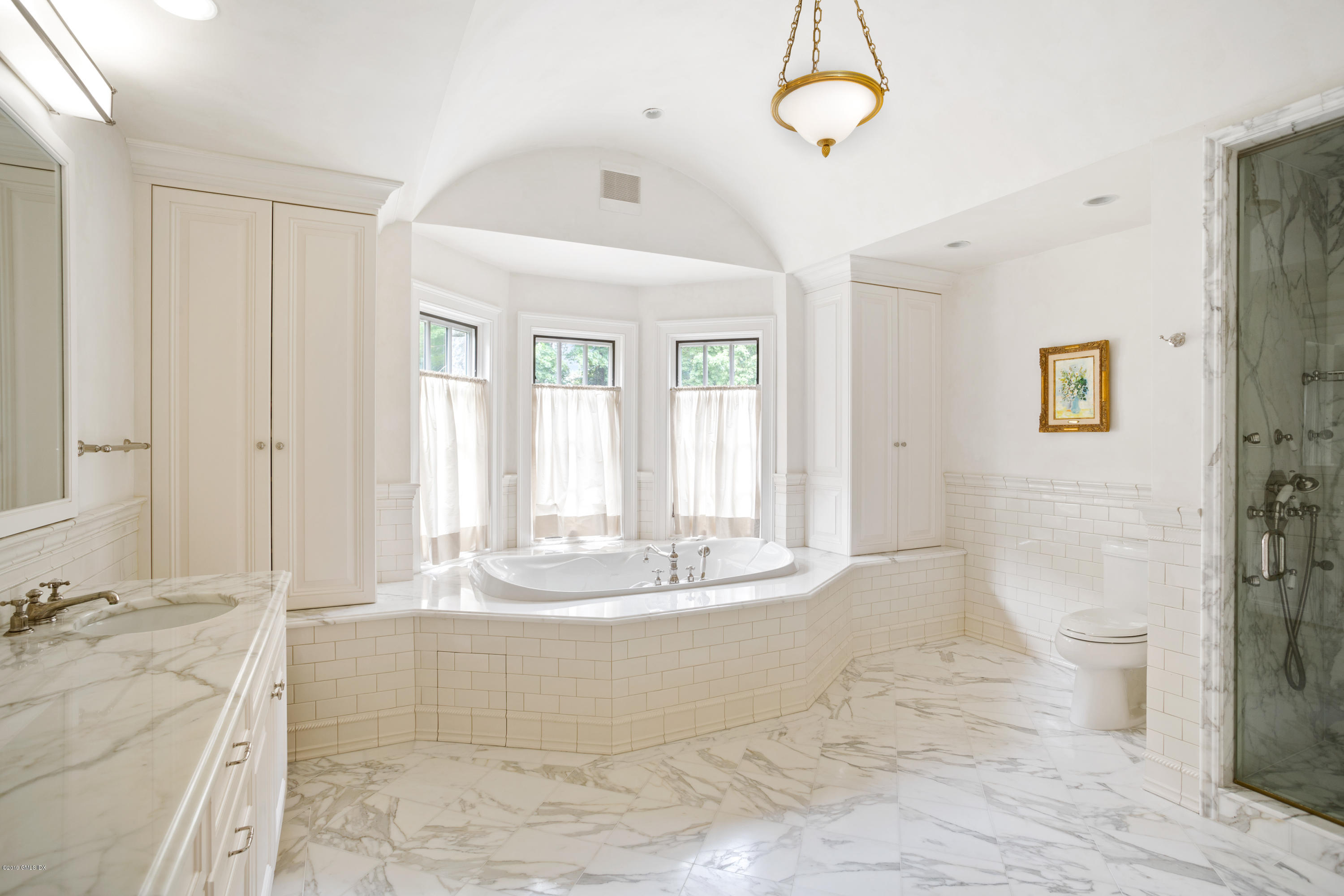 17 Cameron Drive Greenwich, CT 06831 - Photo 18 of 41 a view of a bathroom with a tub shower and sink