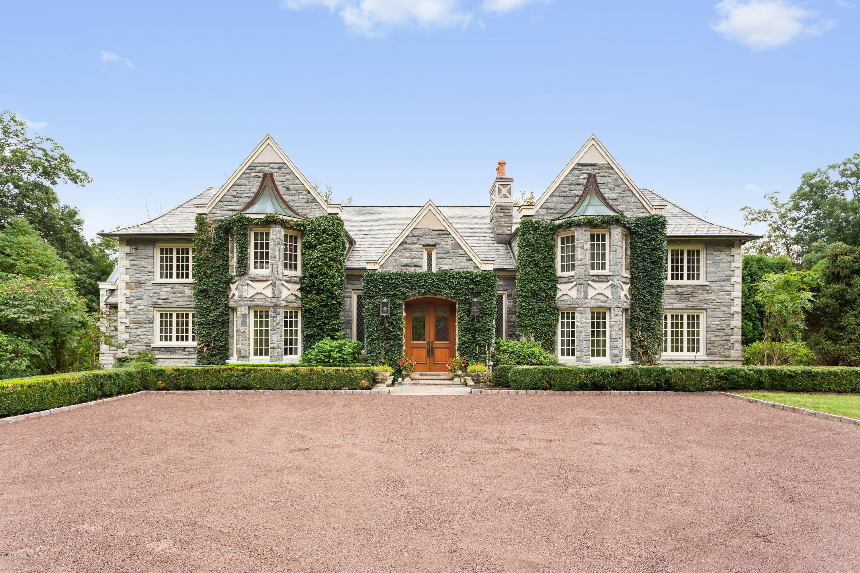 17 Cameron Drive Greenwich, CT 06831 - Photo 2 of 41 a front view of a house with a yard