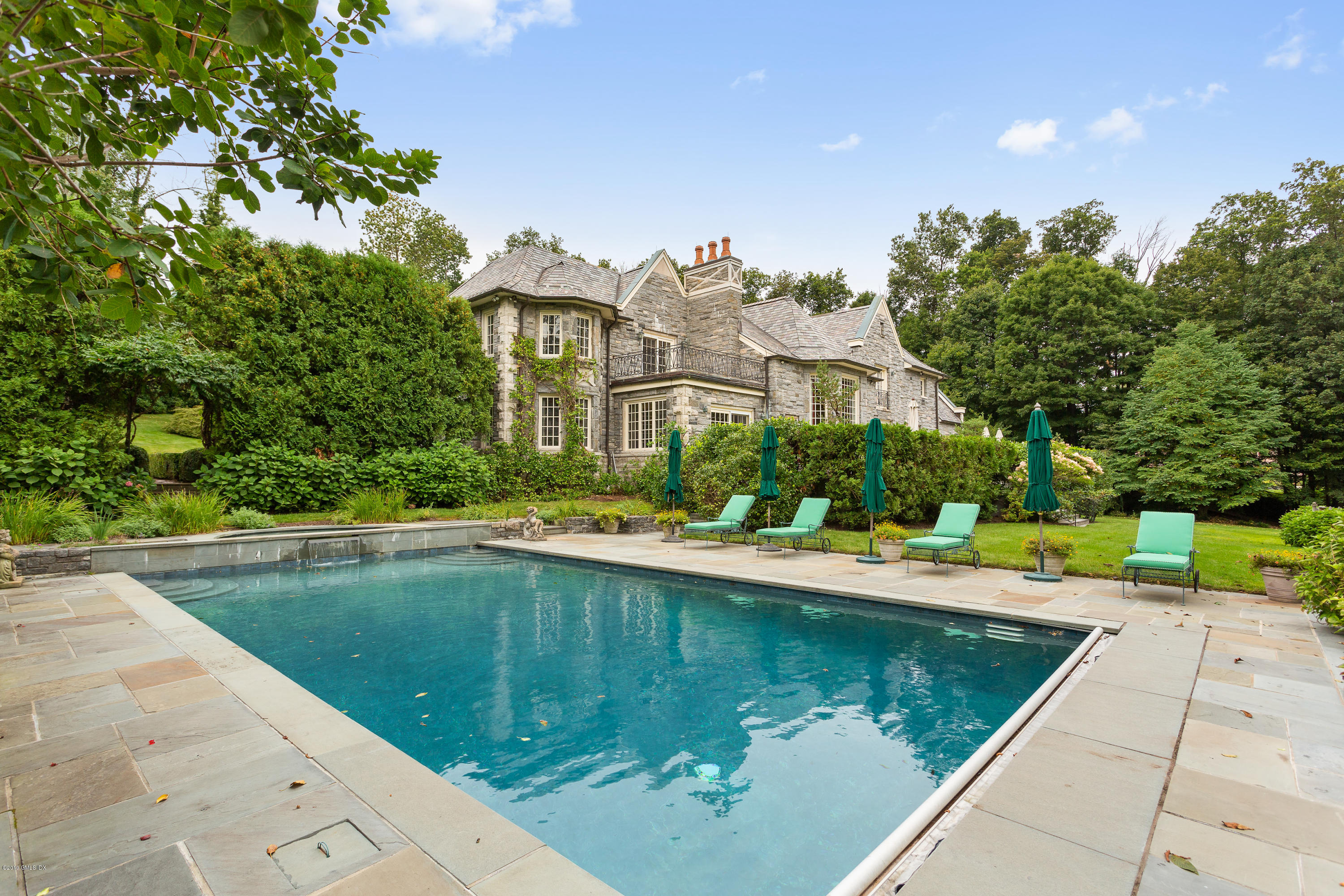 17 Cameron Drive Greenwich, CT 06831 - Photo 34 of 41 a view of a house with pool and chairs