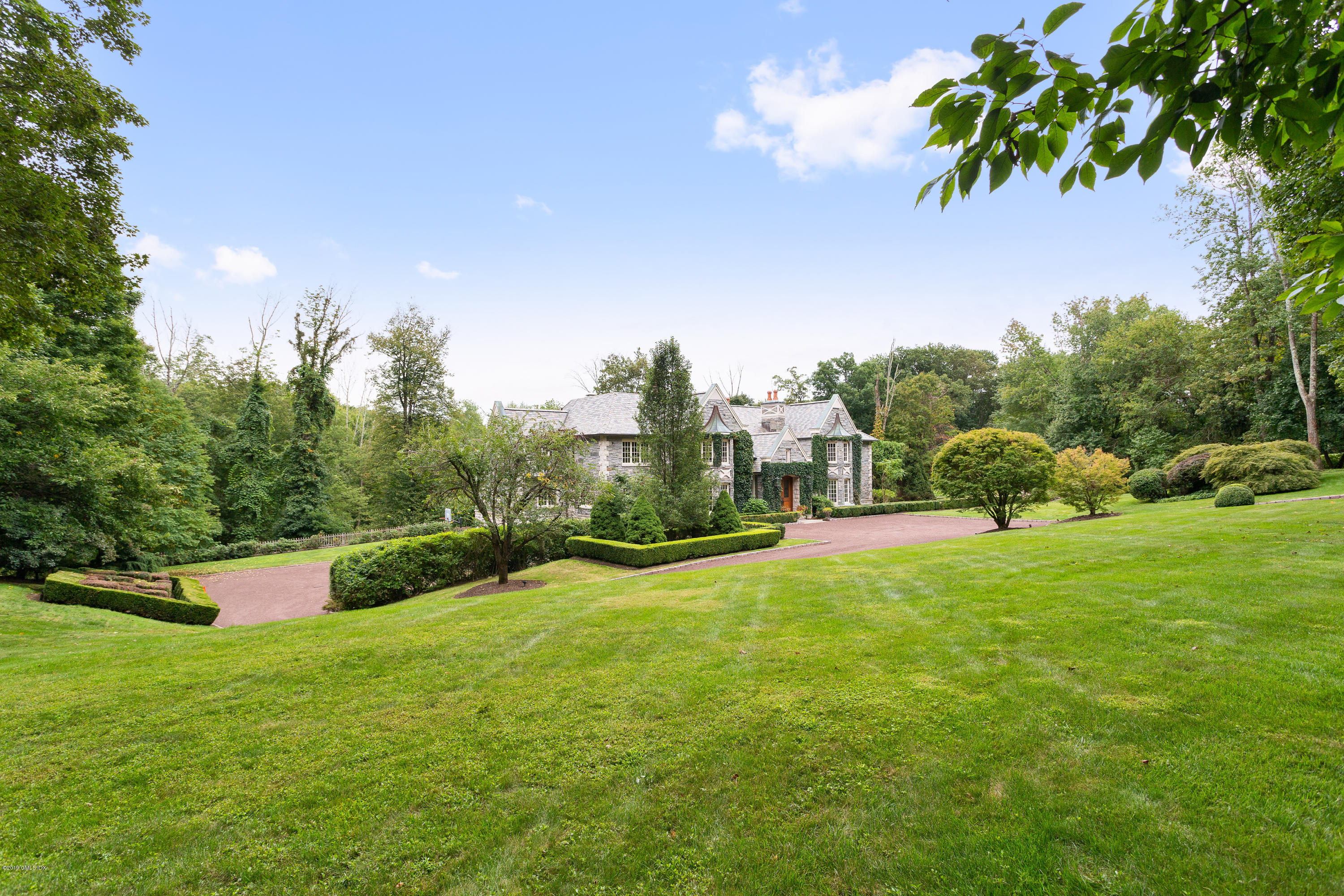 17 Cameron Drive Greenwich, CT 06831 - Photo 4 of 41 a view of a garden with a building in the background