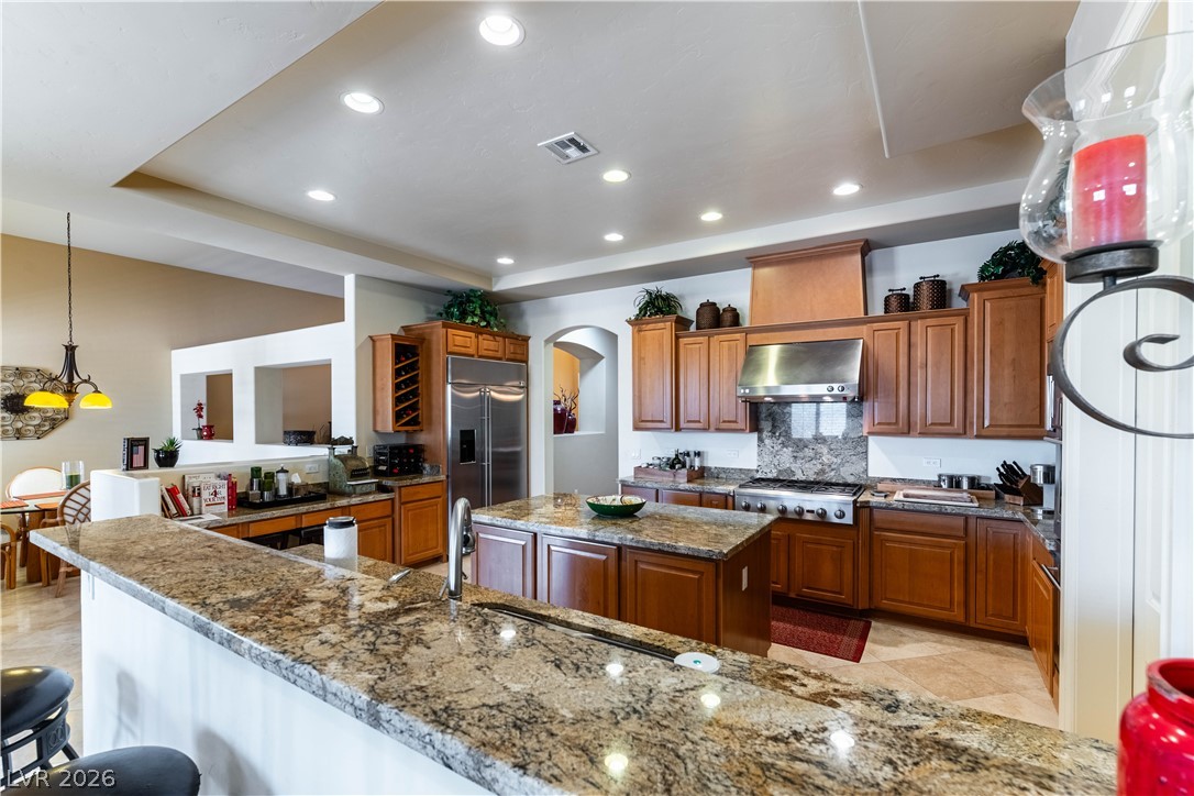 3661 Riley Ann Avenue Las Vegas, NV 89139 - Photo 13 of 42 An inviting kitchen with warm wooden cabinetry and elegant stone counters.