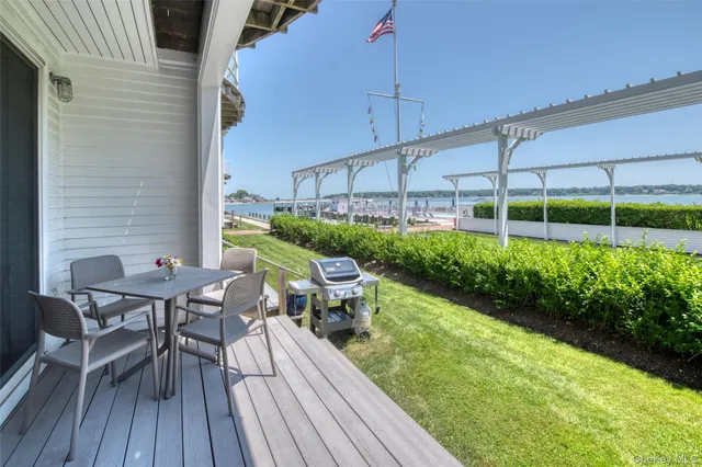 a view of a patio with table and chairs potted plants with wooden floor