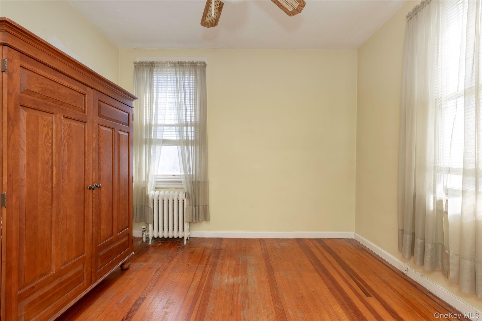 100 Marine Street Bronx, NY 10464 - Photo 14 of 25 a view of a room with wooden floor and windows