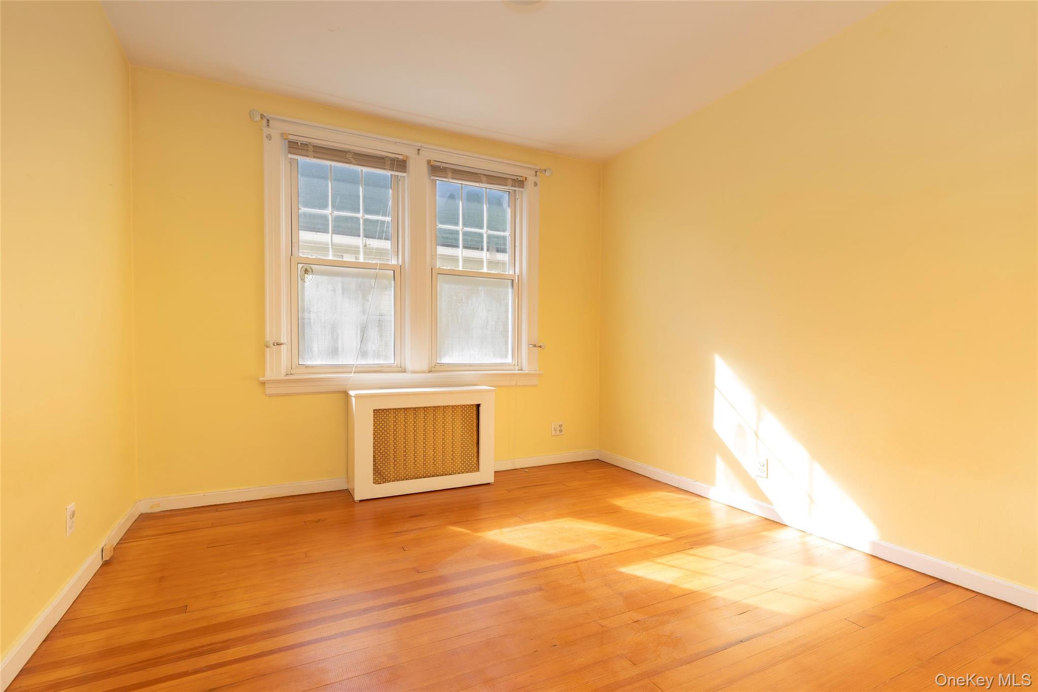 100 Marine Street Bronx, NY 10464 - Photo 16 of 25 a view of an empty room with wooden floor and a window