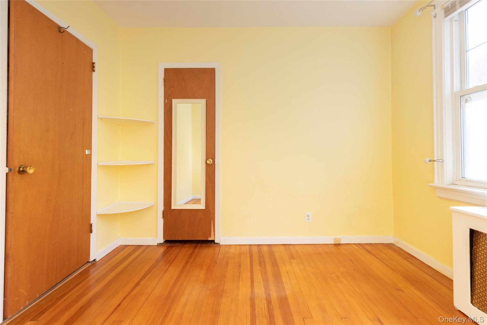 100 Marine Street Bronx, NY 10464 - Photo 18 of 25 a view of empty room with wooden floor and fan