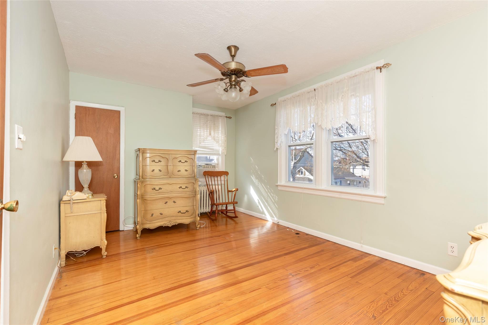 100 Marine Street Bronx, NY 10464 - Photo 19 of 25 a bedroom with a bed and wooden floor