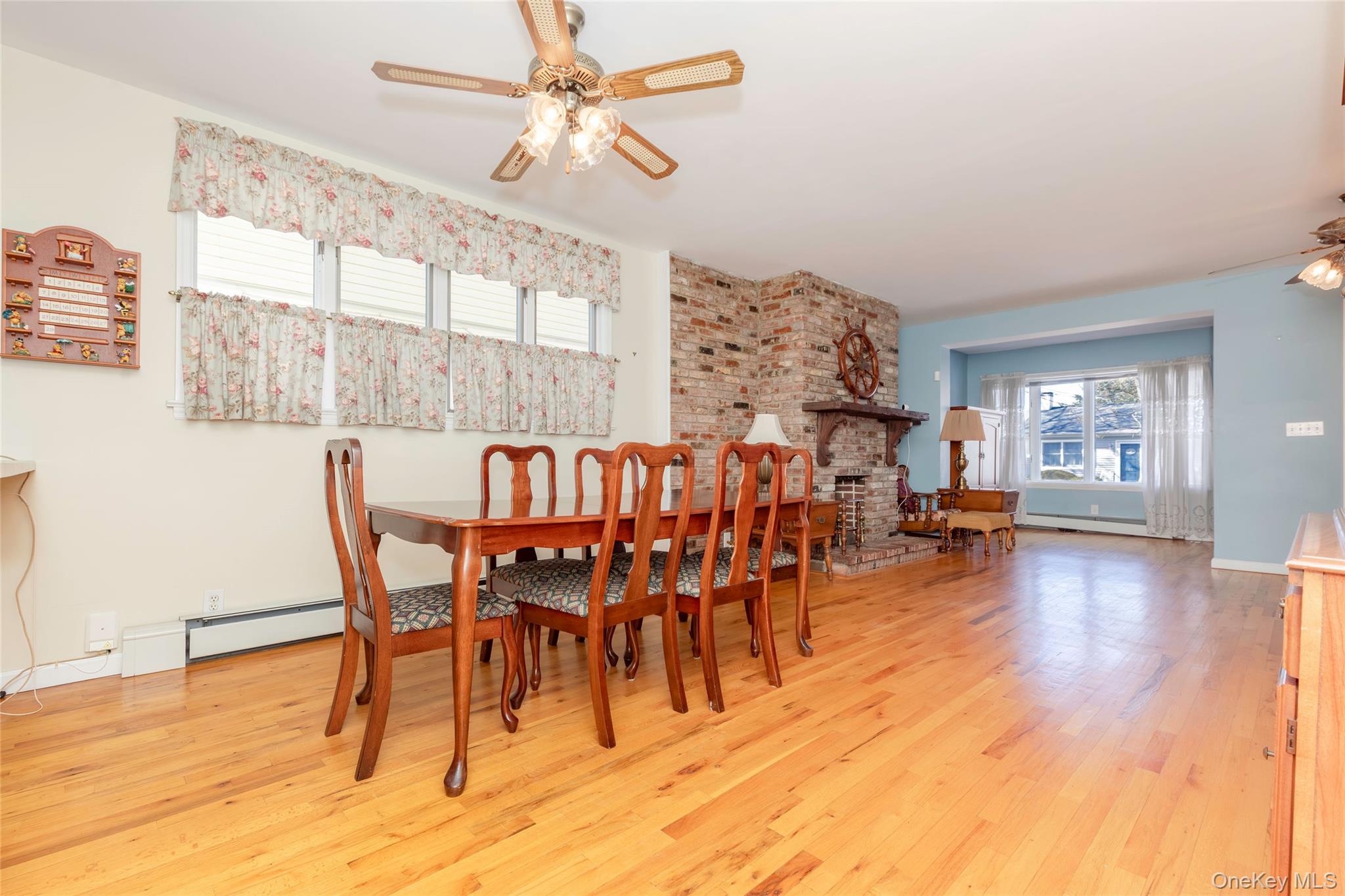 100 Marine Street Bronx, NY 10464 - Photo 6 of 25 a dining room with furniture a chandelier and wooden floor