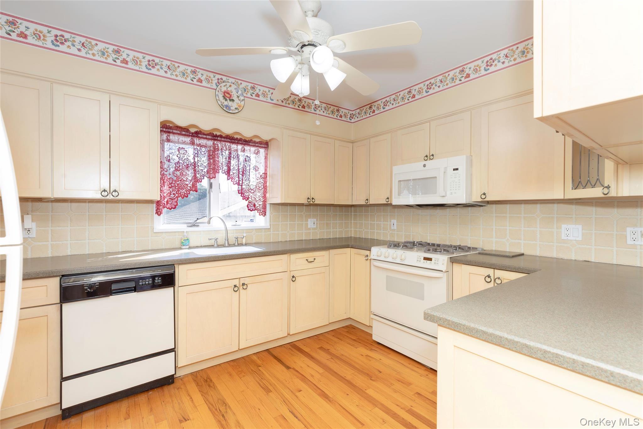 100 Marine Street Bronx, NY 10464 - Photo 8 of 25 a kitchen with cabinets a sink and appliances