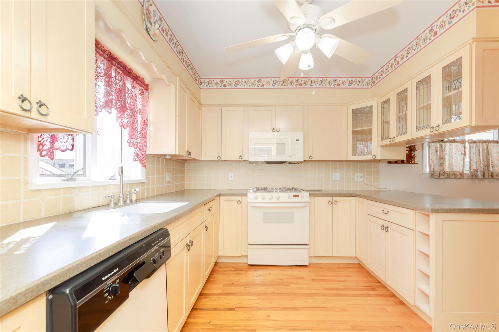100 Marine Street Bronx, NY 10464 - Photo 9 of 25 a large kitchen with stainless steel appliances granite countertop a sink and dishwasher a stove with wooden floor