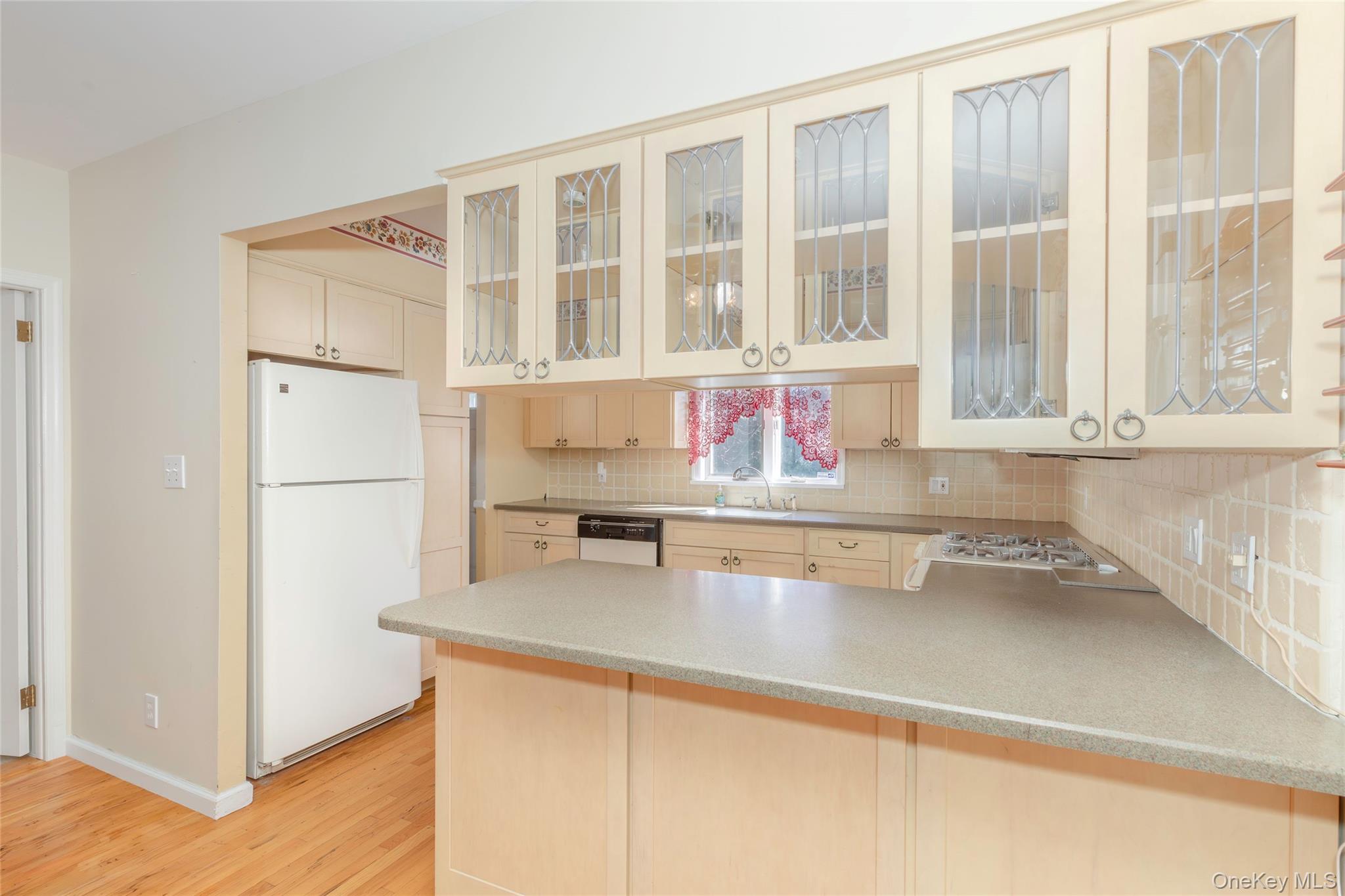 100 Marine Street Bronx, NY 10464 - Photo 10 of 25 a kitchen with stainless steel appliances granite countertop a sink and a refrigerator