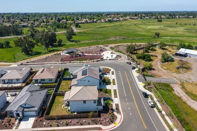 an aerial view of residential houses with outdoor space