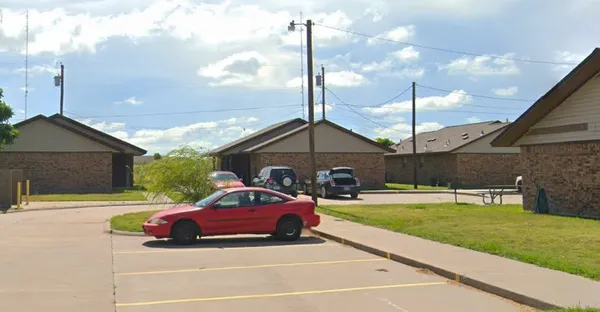 a car parked in front of a house with a yard