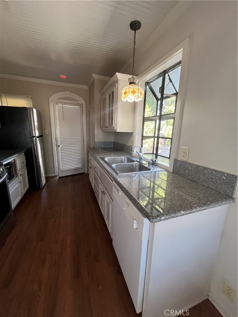 1026 5th Street Calimesa, CA 92320 - Photo 11 of 19 a kitchen with stainless steel appliances granite countertop a sink a stove top oven a counter space and cabinets