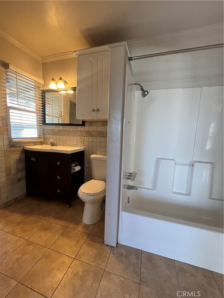 1026 5th Street Calimesa, CA 92320 - Photo 14 of 19 a bathroom with a sink a toilet and bathtub