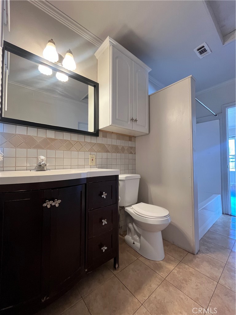 1026 5th Street Calimesa, CA 92320 - Photo 16 of 19 a bathroom with a toilet sink and mirror
