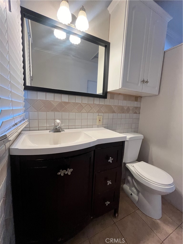1026 5th Street Calimesa, CA 92320 - Photo 17 of 19 a bathroom with a sink vanity and toilet