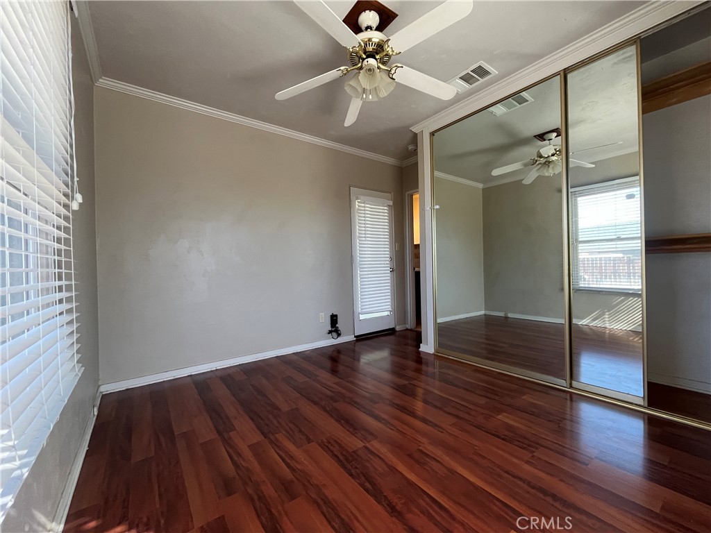 1026 5th Street Calimesa, CA 92320 - Photo 18 of 19 wooden floor in an empty room with a window