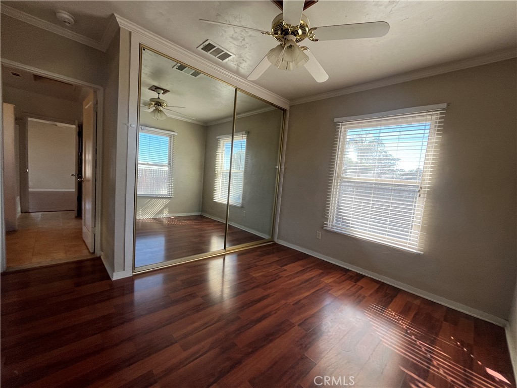 1026 5th Street Calimesa, CA 92320 - Photo 19 of 19 a view of an empty room with wooden floor and a window