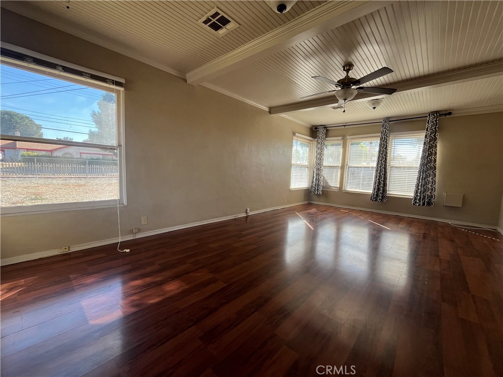 1026 5th Street Calimesa, CA 92320 - Photo 7 of 19 a view of empty room with wooden floor and fan
