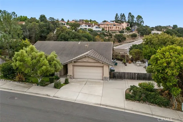 an aerial view of a house with a yard and potted plants