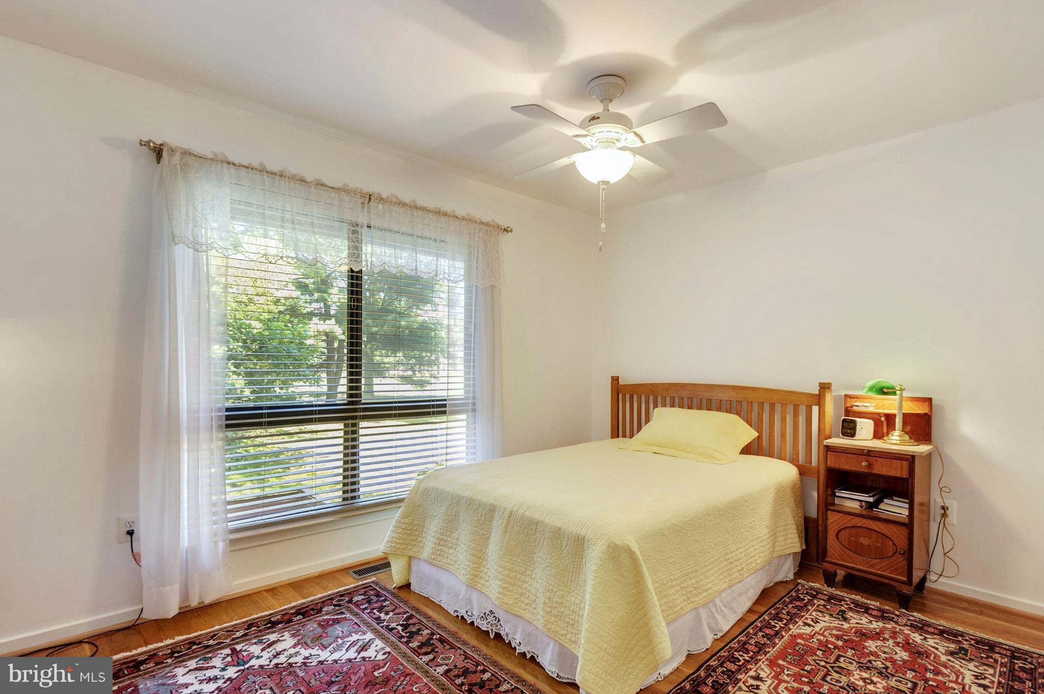 11796 Indian Ridge Road Reston, VA 20191 - Photo 17 of 30 a bedroom with a bed and a chandelier