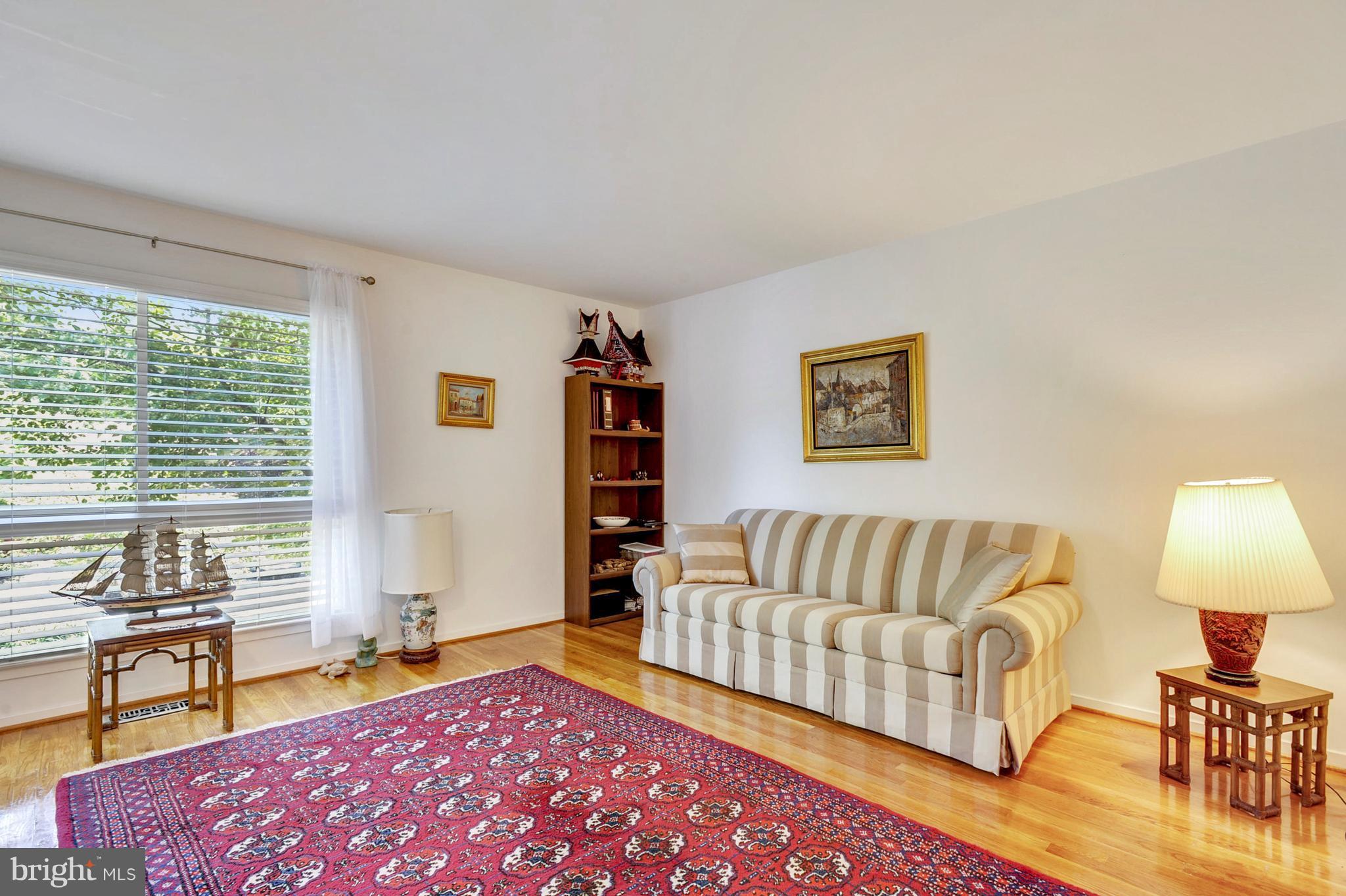 11796 Indian Ridge Road Reston, VA 20191 - Photo 19 of 30 a spacious bedroom with a bed and a couch