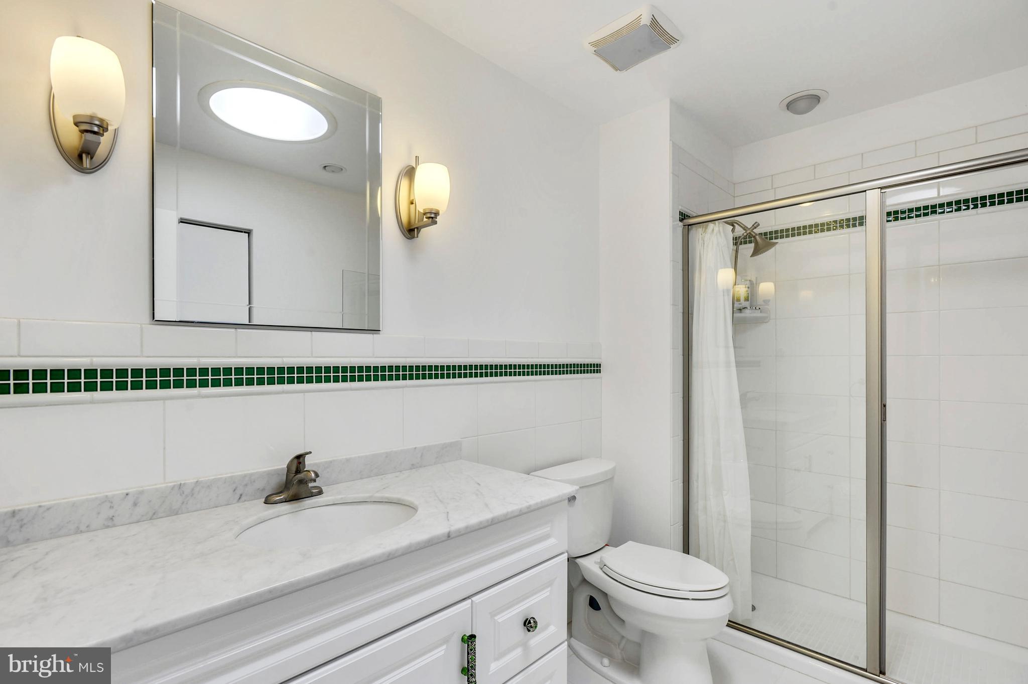 11796 Indian Ridge Road Reston, VA 20191 - Photo 20 of 30 a bathroom with a granite countertop sink mirror vanity and toilet