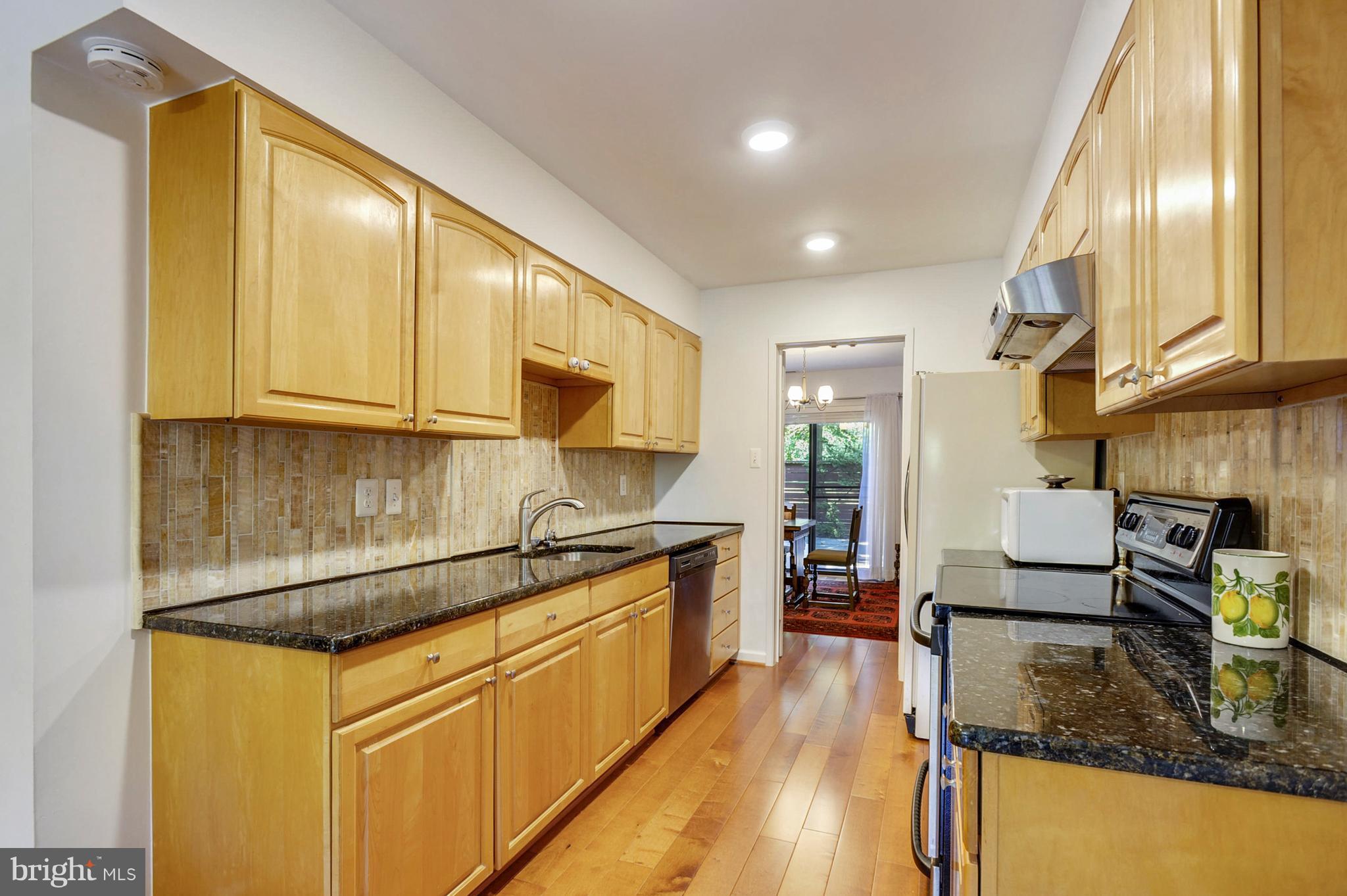 11796 Indian Ridge Road Reston, VA 20191 - Photo 3 of 30 a kitchen with stainless steel appliances granite countertop a sink stove and cabinets