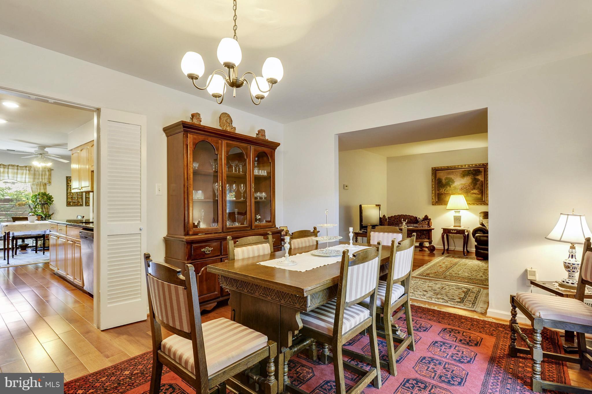 11796 Indian Ridge Road Reston, VA 20191 - Photo 7 of 30 a view of a dining room with furniture a chandelier and wooden floor