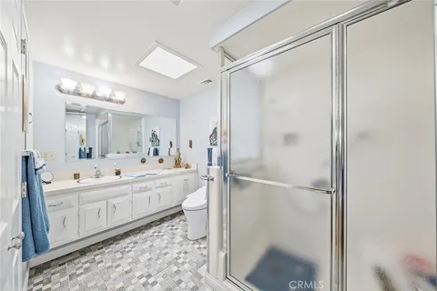 a bathroom with a double vanity sink mirror double and shower