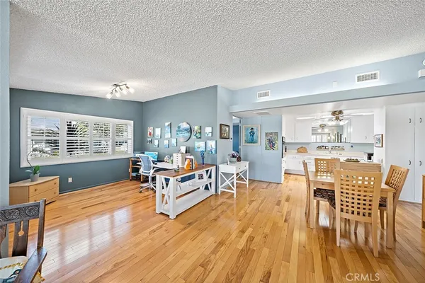 a living room with furniture dining table and a large window