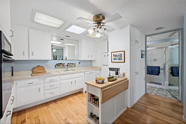 a kitchen with a stove cabinets and window