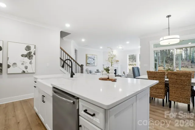 a kitchen with stainless steel appliances a white counter space a sink and cabinets