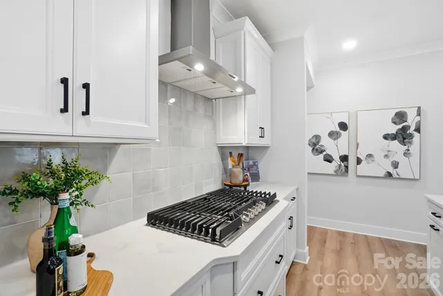 a dining room with furniture wooden floor a rug and a chandelier