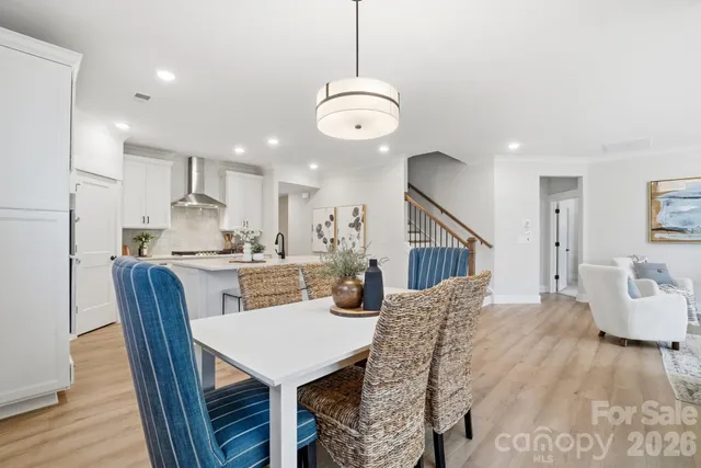 a living room with furniture a fireplace and a potted plant
