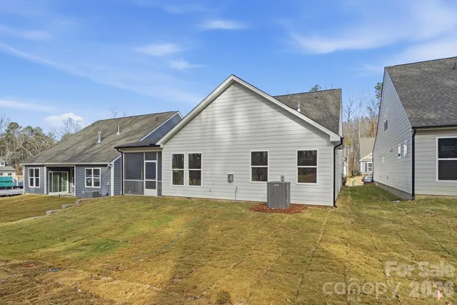 a view of swimming pool with large trees