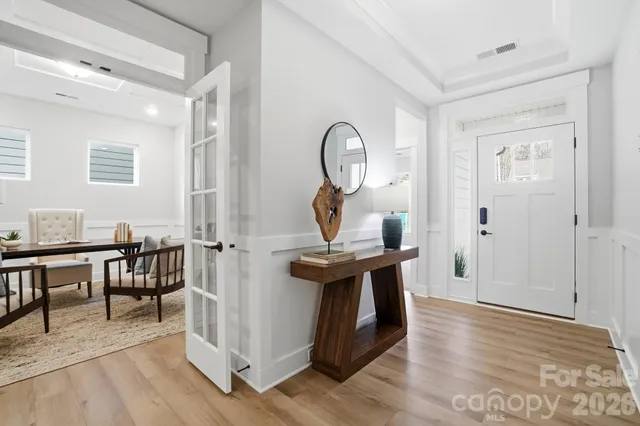 a large white kitchen with a large window