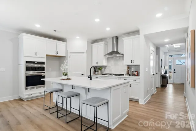a kitchen with white cabinets and white appliances