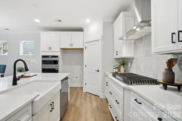 a kitchen with a sink a counter top space and appliances