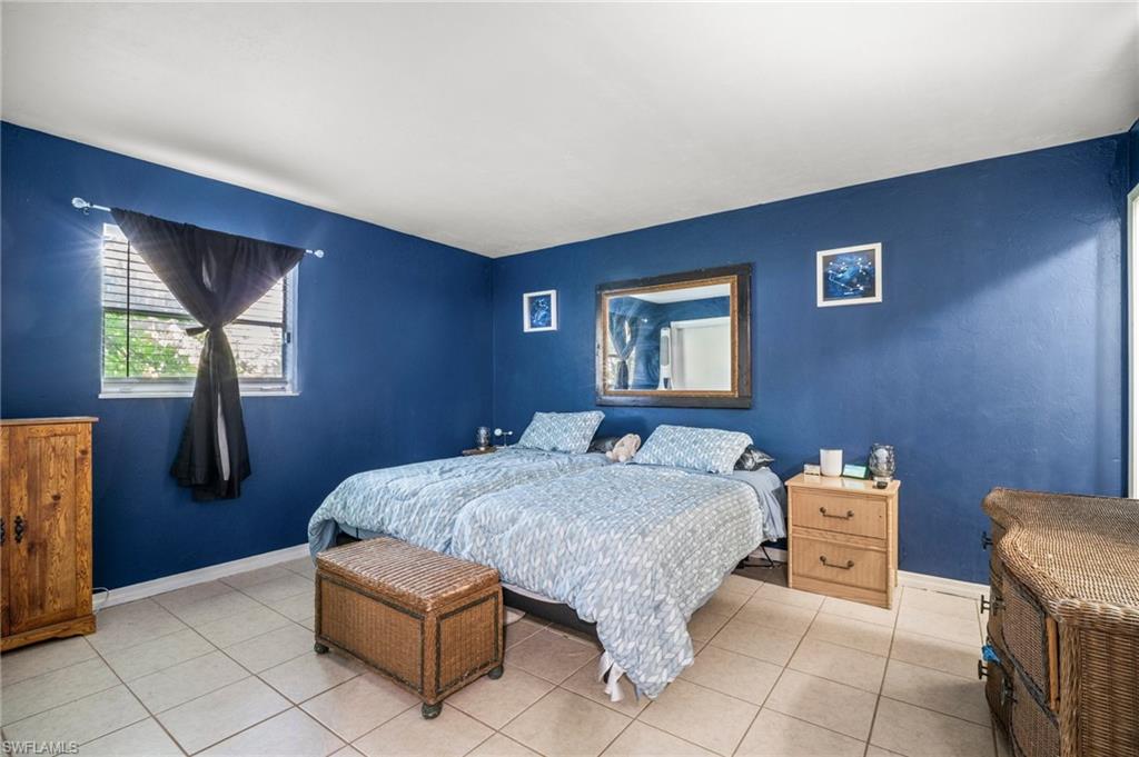 115 Georgia Road Lehigh Acres, FL 33936 - Photo 22 of 26 Bedroom featuring light tile patterned floors and baseboards