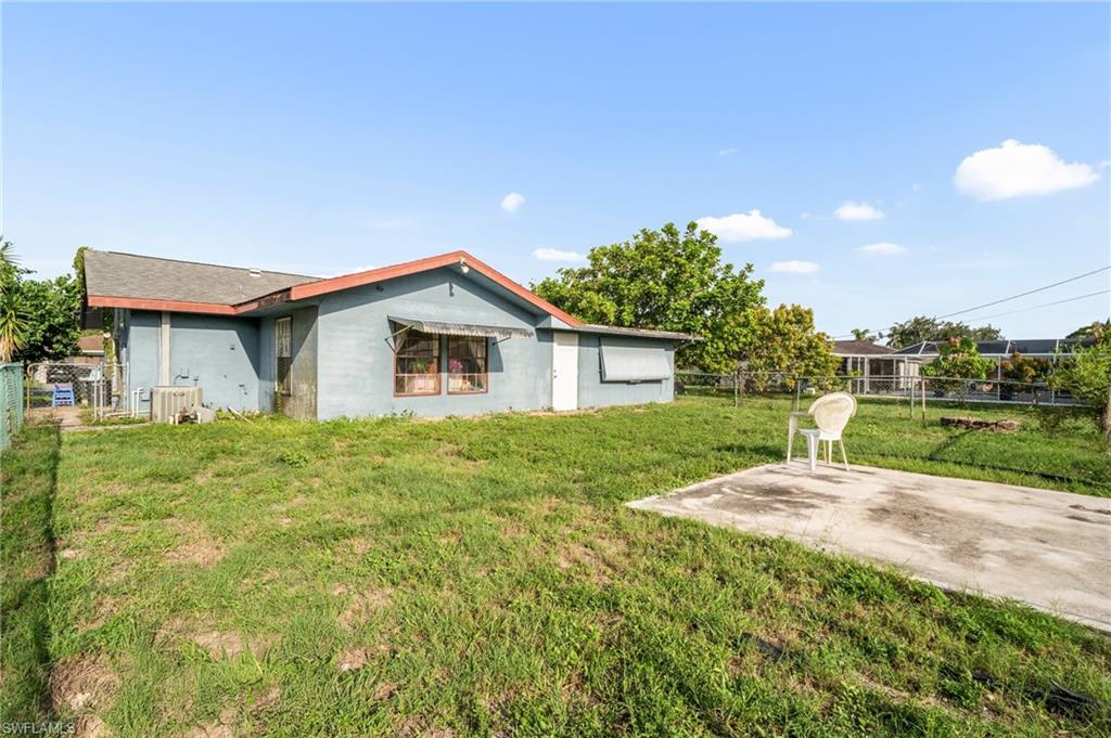 115 Georgia Road Lehigh Acres, FL 33936 - Photo 24 of 26 Back of property featuring a patio area and stucco siding