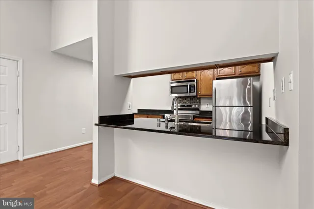 a kitchen with stainless steel appliances a sink and a refrigerator