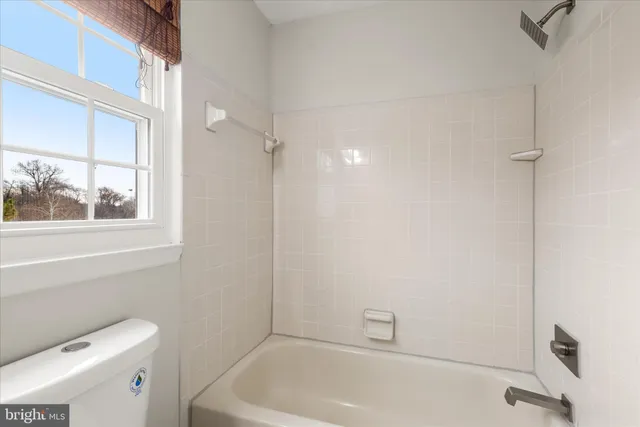 a bathroom with a bathtub and window