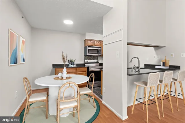 a view of a dining room with furniture and wooden floor