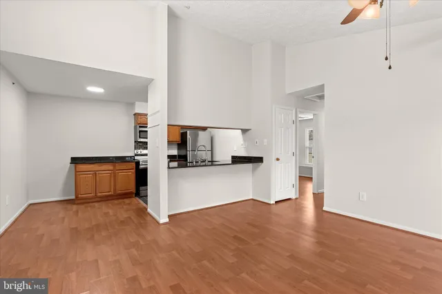 a kitchen view with stainless steel appliances a refrigerator and a stove top oven
