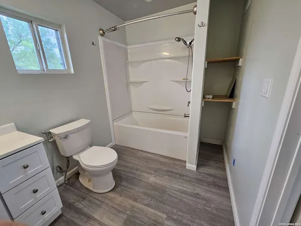 a view of a room with wooden floor and small space