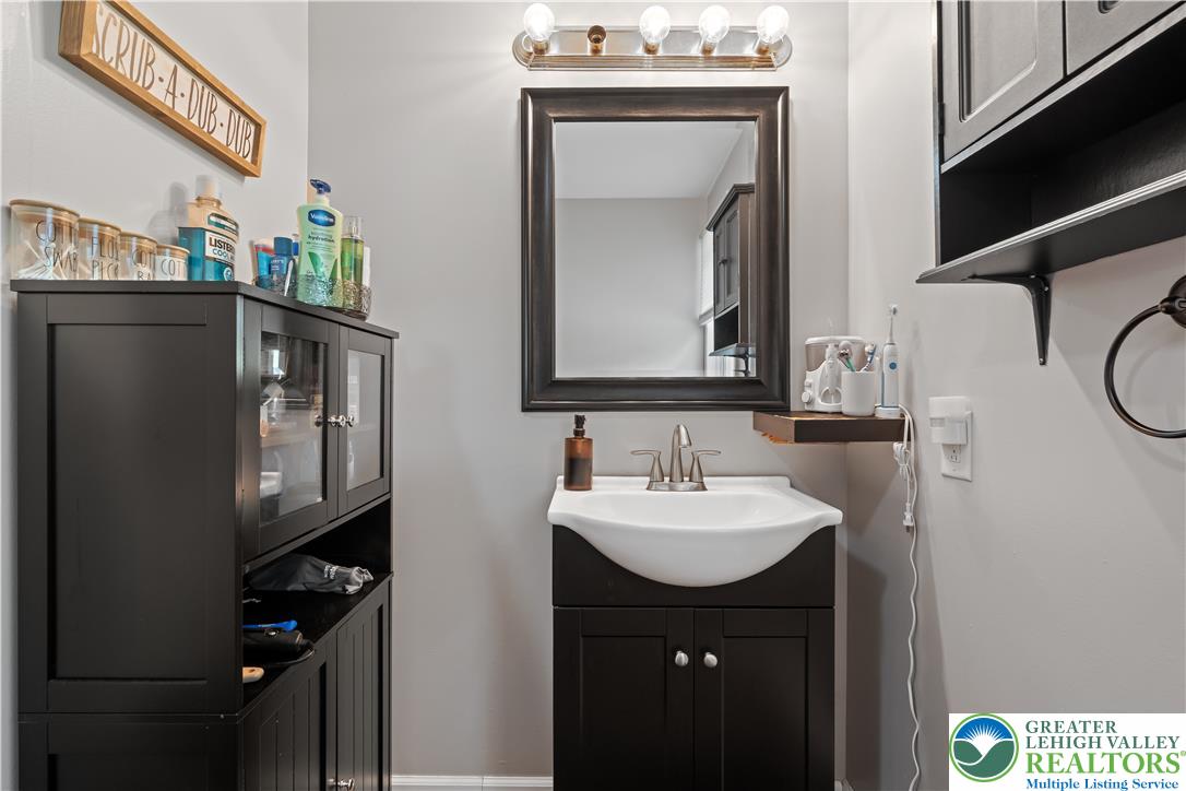 50 Kohls Road Northampton, PA 18067 - Photo 33 of 54 Functional vanity with classic dark cabinetry and a clean basin.