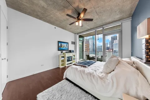a bedroom with a large bed and a large window