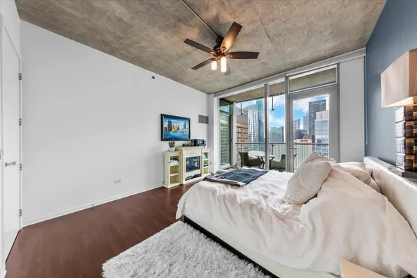 a bedroom with a large bed and a large window